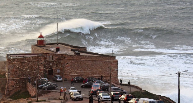Big wave in Nazare and the lighthouse