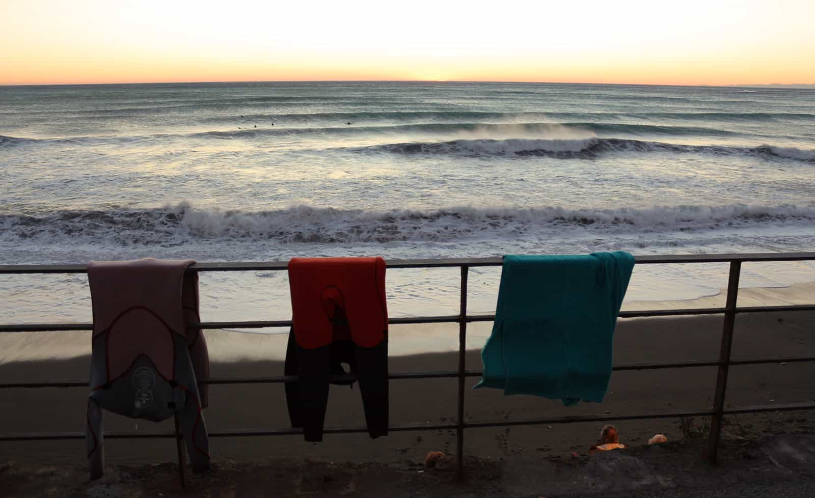 Drying our wetsuits and watching the surf