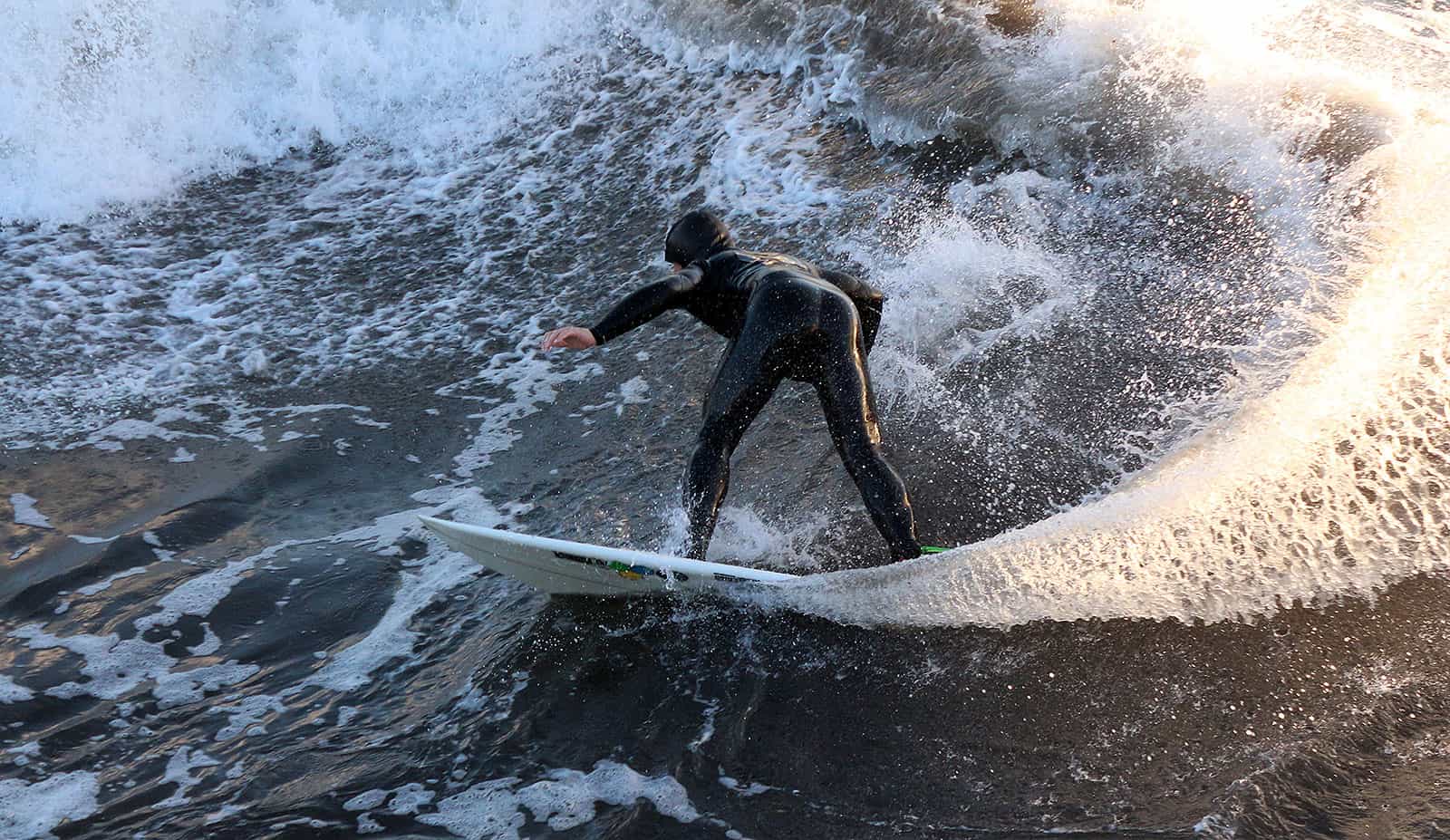 Surfer and water drops in the sun.