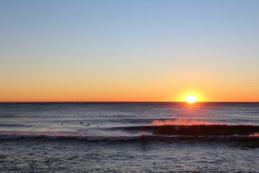 Surfing lineup at sunset